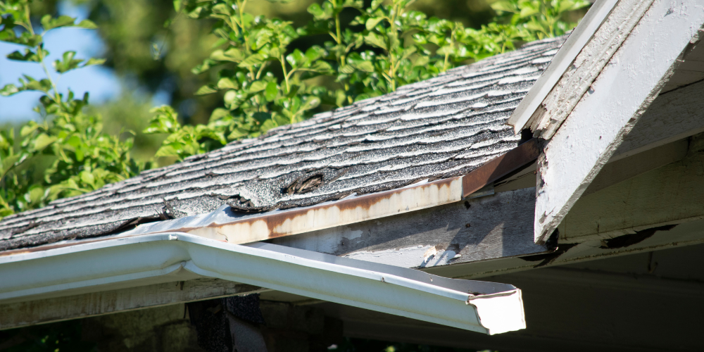 Image showing severely damaged gutter with visible cracks, rust, and sagging, indicating the need for immediate repair or replacement by G. Fedale Roofing and Siding.