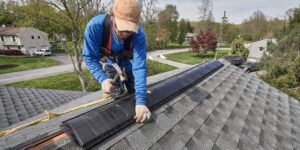 How to prevent attic moisture. Image of G. Fedale roofer securing roofing.